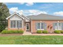 Attractive brick home featuring a well-manicured lawn and tidy landscaping at 11346 Olde Turnbury Ct, Charlotte, NC 28277