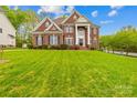 Attractive brick home with a large, green front yard perfect for outdoor activities at 130 Weeping Spring Dr, Mooresville, NC 28115