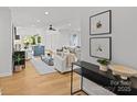 Sunlit living room with hardwood floors, modern furnishings, and an open layout connecting to the kitchen at 1330 Dean St, Charlotte, NC 28216