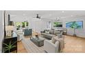 Open-concept living space with hardwood flooring, a ceiling fan, and a dining area at 1330 Dean St, Charlotte, NC 28216