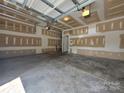 Spacious two-car garage with ample room for storage and parking, featuring an automatic door opener at 13409 Glasgow Green Ln, Charlotte, NC 28213
