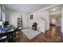 Bright living room features hardwood floors and staircase at 1717 Mill Creek Sw Ln, Concord, NC 28025