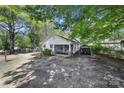 Well-maintained single-story home featuring a screened-in porch and covered parking area at 216 W 16Th St, Kannapolis, NC 28081