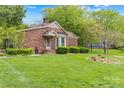 Quaint brick home with a well-manicured lawn and charming landscaping at 2234 Hamilton Mill Rd, Charlotte, NC 28270