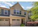 Inviting townhome showcasing a one-car garage, neat lawn, and lush, mature landscaping at 226 Scenic View Ln, Matthews, NC 28104