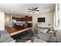 Open living room and kitchen area featuring hardwood floors, stainless steel appliances, and modern decor at 226 Scenic View Ln, Matthews, NC 28104