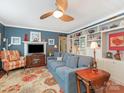 Inviting living room featuring a comfortable blue sofa, fireplace, and custom shelving creating a warm and welcoming space at 2620 Park Rd, Charlotte, NC 28209