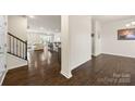 Inviting living room featuring hardwood floors, an open layout, and staircase access at 269 Keating Place Dr, Fort Mill, SC 29708