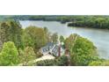 Stunning aerial view of lakeside home with lush greenery and a private, serene setting at 272 Harbor Ridge Dr, Statesville, NC 28677