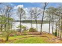 Picturesque backyard view of the lake with a gazebo, private dock, and landscaped grounds at 272 Harbor Ridge Dr, Statesville, NC 28677