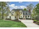 Charming two-story home featuring a well-manicured lawn, classic architecture, and inviting front porch at 272 Harbor Ridge Dr, Statesville, NC 28677