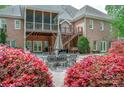 Spacious backyard featuring an outdoor seating area, mature trees and a well-maintained lawn at 305 Caledonia Way, Waxhaw, NC 28173