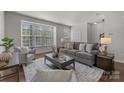 Inviting living room featuring a large window, comfortable seating, and neutral decor at 4056 Zilker Park Dr, Charlotte, NC 28217