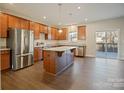 Spacious kitchen featuring an island with stone countertops, stainless steel appliances, and wooden cabinets at 4176 River Run Cir, Hickory, NC 28602