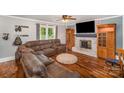 Spacious living room with a brick fireplace, ceiling fan, and a large sectional couch at 44392 Dennis Rd, Albemarle, NC 28001