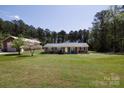 Charming brick ranch home featuring a large front yard and mature trees in a serene setting at 5381 Mount Carmel Rd, Heath Springs, SC 29058