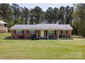 Traditional brick home with green lawn and black shutters at 5381 Mount Carmel Rd, Heath Springs, SC 29058
