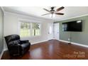 Cozy living room with hardwood floors, a large window, a ceiling fan, and tv at 5381 Mount Carmel Rd, Heath Springs, SC 29058