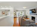Bright living room with hardwood floors, a modern fireplace, and natural light at 576 Scaleybark Rd, Charlotte, NC 28209