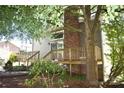 Backyard exterior featuring a deck, brick chimney, and lush greenery, offering a serene outdoor space at 5769 Birch St, Conover, NC 28613