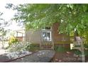 Beautiful backyard featuring a spacious wooden deck, brick chimney, and lush greenery for outdoor enjoyment at 5769 Birch St, Conover, NC 28613