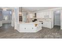 Modern kitchen with white cabinets, quartz countertops, and stainless steel appliances at 618 Circle Trace Rd, Monroe, NC 28110
