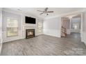 Bright living room with fireplace, ceiling fan, hardwood floors and detailed wall trim at 618 Circle Trace Rd, Monroe, NC 28110