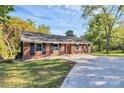 Well-maintained brick home with a manicured lawn and long concrete driveway at 680 Lakeside Dr, Rock Hill, SC 29730