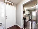 Entryway view showing the kitchen with white cabinets and stainless steel appliances at 7820 Elm Tree Ln, Charlotte, NC 28227