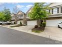 Attractive townhome with stone facade, two-car garage, and well-maintained front yard at 832 Summerlake Dr, Fort Mill, SC 29715