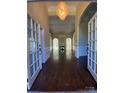 Inviting foyer with hardwood floors, a chandelier and an arched doorway leading to the living space at 9113 Oak Bluff Ct, Waxhaw, NC 28173