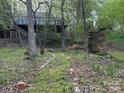 Exterior shot of an outdoor stone fireplace with a wood home in the background at 1224 Island Creek Dr, Troy, NC 27371