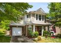 Beautiful home with a brick facade, complemented by mature trees and a well-manicured lawn at 12319 Cumberland Cove Dr, Charlotte, NC 28273