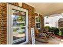 Cozy front porch with rocking chairs, a brick facade, and a welcoming spring wreath at 12319 Cumberland Cove Dr, Charlotte, NC 28273
