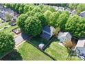 Aerial view of a home with a fenced backyard, mature trees, and a storage shed at 13206 Meadowmere Rd, Huntersville, NC 28078