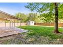 A fenced backyard with a storage shed and covered patio, ideal for outdoor living at 13206 Meadowmere Rd, Huntersville, NC 28078