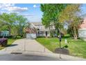 Inviting brick home with a spacious front yard, long driveway, and classic covered porch at 15407 Saxon Trace Ct, Huntersville, NC 28078