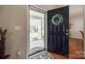 Inviting foyer showcasing beautiful hardwood floors, glass storm door, and a welcoming entrance at 15613 Troubadour Ln, Huntersville, NC 28078