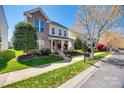 Inviting two-story home featuring manicured lawn and landscaping in a suburban setting at 15613 Troubadour Ln, Huntersville, NC 28078