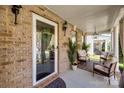 Relaxing front porch with cozy seating area, decorative rug, and charming decor at 15613 Troubadour Ln, Huntersville, NC 28078