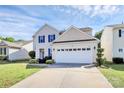 Traditional two story home with a two car garage and manicured lawn and landscaping at 17546 Westmill Ln, Charlotte, NC 28277