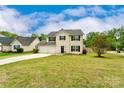 Traditional two-story house with a manicured front lawn, attached two car garage and black shutters at 225 Carrie Ct, Concord, NC 28027