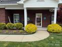 Inviting front porch with chairs, brick facade, and manicured landscaping at 227 Crystal Springs Ln, Shelby, NC 28150
