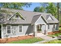 Charming home exterior with classic architecture, manicured lawn, and inviting entryway at 234 Winding Shore Rd, Troutman, NC 28166