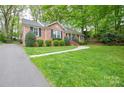 Beautiful front yard showing lawn, walkway, landscaping and brick facade of the home at 2429 Sugar Mill Rd, Charlotte, NC 28210
