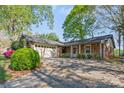 Brick home with attached garage and a long driveway framed by mature trees at 2643 Providence Dr, Gastonia, NC 28052