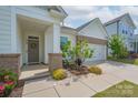 Charming home featuring a welcoming front entrance with a gray door and neatly landscaped flower beds at 2890 Westshore Pl, Denver, NC 28037