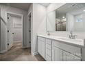Bright bathroom featuring double vanity with quartz countertops, modern fixtures, and a walk-in closet at 291 Bezelle Ave, York, SC 29745