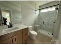 Modern bathroom with a glass-enclosed shower, sleek vanity, and stylish tile flooring at 3214 Mcharney Dr # 34, Harrisburg, NC 28075