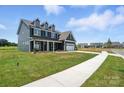 Charming two-story home with a well-manicured lawn on a sunny day in a walkable neighborhood at 3214 Mcharney Dr # 34, Harrisburg, NC 28075